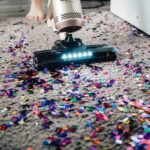 a person using a vacuum to clean a carpet